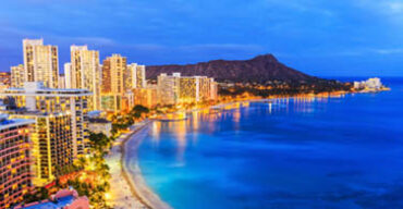 Pictured: A coastline view of the city of Honolulu at night.