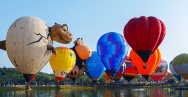 Pictured: Hot air ballons over a lake.