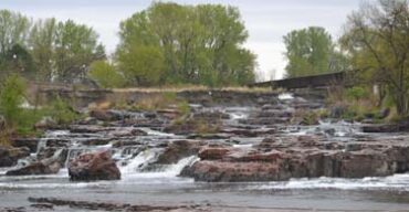 Pictured: River water running down rocks in Sioux Falls South Dakota.